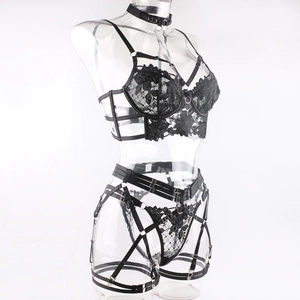 Detail of black floral embroidery and metallic ring connectors on sexy lace lingerie set
