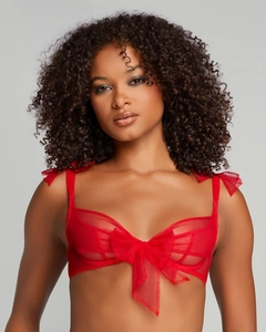 Detail of red sheer mesh bra featuring delicate bow accents and transparent texture