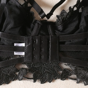 Detail of floral lace lingerie showing multi-strap back design and triple hook closure