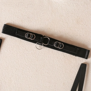 Detail of black gothic garter belt with silver metal rings and high-elastic textured webbing