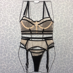 Three-piece black lace and nude mesh lingerie set with underwire bra and garter belt