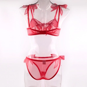 Detail view of red mesh lingerie set with sheer bow straps and matching panty on mannequin