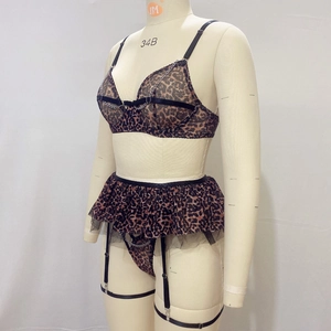 Detail of leopard print lingerie with silver metal chains and sheer mesh texture