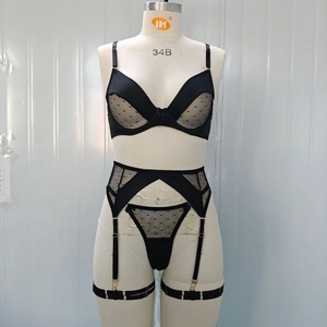 Detail of black polka dot mesh lingerie set with garter belt and strap details