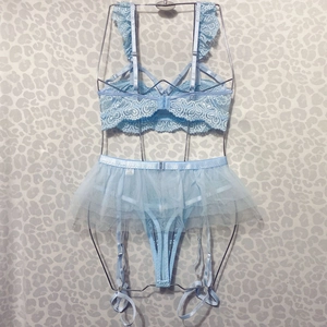 Detailed view of light blue lace bra set with sheer mesh skirt and garter straps