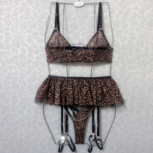 Detailed view of leopard print lingerie with silver metal chains and sheer mesh ruffles