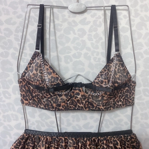 Detail of leopard print mesh lingerie set featuring silver metal chain and adjustable straps