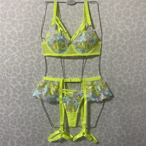 Detailed embroidery on neon yellow lace lingerie set with floral patterns and mesh