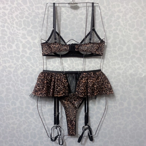 Detail of leopard print mesh bra and garter belt set with elegant metal chain straps