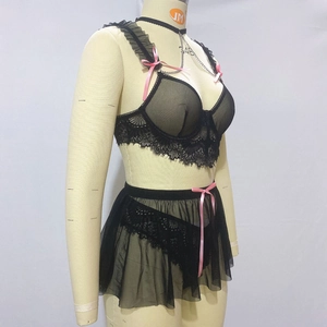 Detail of black eyelash lace lingerie set featuring pink bows and sheer mesh skirt