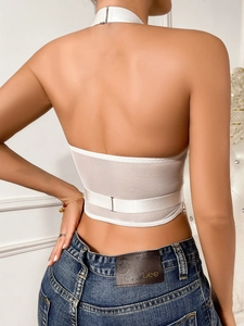 Detail of white lace halter top with sheer mesh, backless design and elastic hem straps