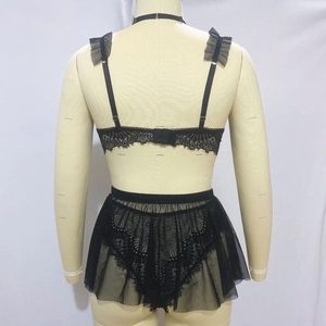 Back view of black lace lingerie set with ruffled straps and sheer mesh skirt detail