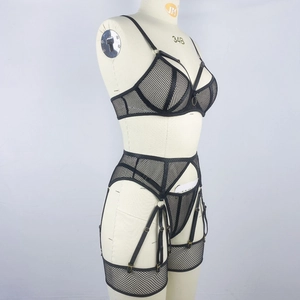 Close-up of black mesh lingerie set with metal rings and strappy crossover detailing
