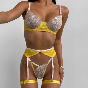 Detailed close-up of yellow lace lingerie set featuring colorful floral embroidery