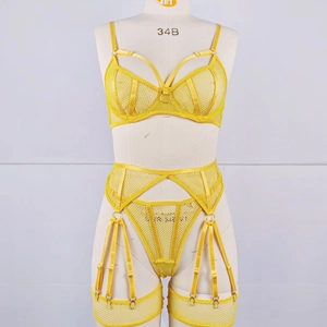 Detail of yellow mesh lingerie set featuring cross straps and adjustable garter belt