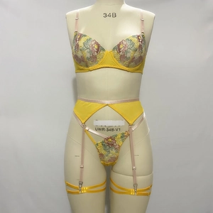 Detailed embroidery on yellow 3-piece lingerie set with bra, garter and thong