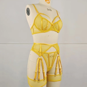 Detailed close-up of yellow fishnet lace lingerie set with underwire bra and garter belt