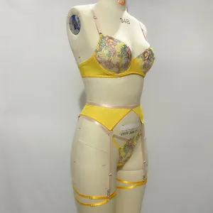 Detail of floral embroidery on yellow lace lingerie set with adjustable garter straps