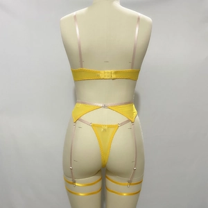 Detailed back view of yellow sheer mesh lingerie set with floral embroidery and buckles