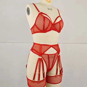 Detail of red mesh lingerie set with metal ring accent and leg harness on mannequin