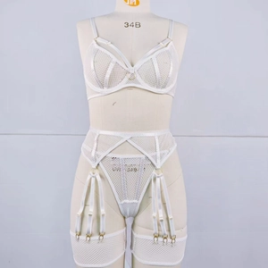 Detail view of white mesh lingerie set with underwire bra and strappy garter belt