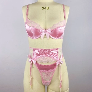 Detail of pink satin lingerie set with floral lace, underwire bra, and delicate bows