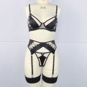 Detail showing sexy black lingerie set with silver chains and mesh textures on mannequin