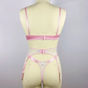 Detail view of pink satin lingerie set back with lace trim and adjustable garter buckles