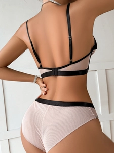 Detailed back view of mesh lingerie set featuring pink sheer panels and black satin straps