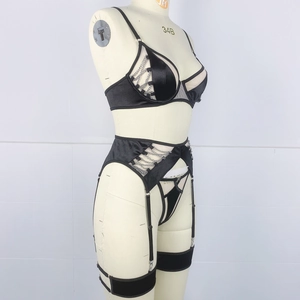 Detailed side view of black lingerie set with silver chains and garter belt on mannequin