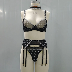 Detailed view of polka dot lace lingerie set featuring underwire bra and garter belt