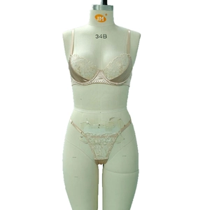 Elegant apricot floral embroidery satin lingerie set with lace bra and thong on mannequin