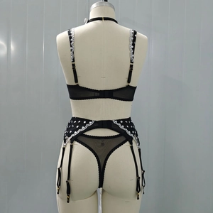 Rear view of black sheer mesh lingerie set with polka dots and lace details on mannequin