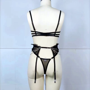 Three-piece black lace lingerie set with rhinestone chains and strappy detailing