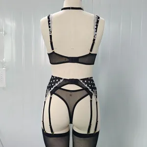Rear view of black sheer polka dot mesh lingerie set with white lace embroidery detail