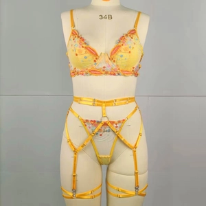 Close-up of yellow floral embroidery detail on underwired lace bra and garter set