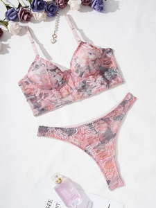 Detailed flat-lay of pink floral lace lingerie set with underwire bra and thong