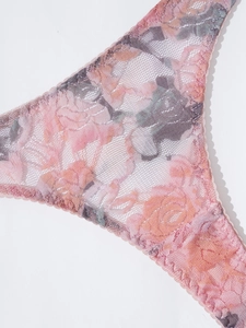Macro shot of pink floral lace panty detailing delicate mesh and scalloped edges