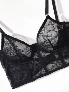 Detailed view of black floral lace bra with underwire support and sheer mesh paneling