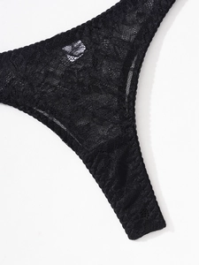 Detail shot of black floral lace underwear featuring intricate semi-transparent patterns