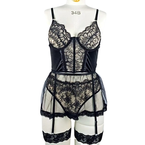 Lace lingerie set with boned corset and garter belt on a mannequin in a studio setting