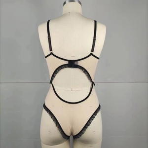 Detail of black lace teddy lingerie with ruffle trim and adjustable back straps