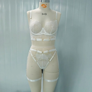 Detailed view of white floral lace lingerie set with garters and adjustable straps