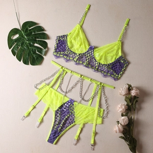 Detail view of lace lingerie set with silver chains and purple bow accents