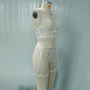 Detailed view of white floral eyelash lace lingerie set with garters and metal buckles