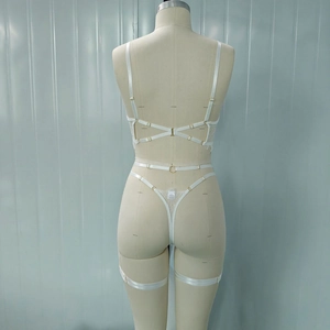 Detail of white lace lingerie set with strappy back design and golden metal buckles