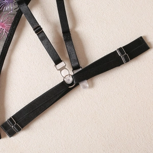 Close-up of adjustable elastic strap with metal buckle and floral embroidery on mesh fabric