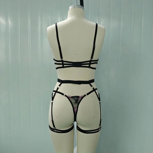 Rear view of black strappy lingerie set with pink floral embroidery and thigh garters