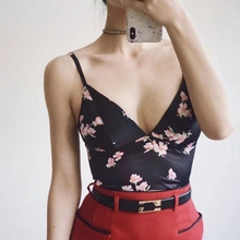 Detail of floral black satin camisole with pink blossom print and V-neckline design