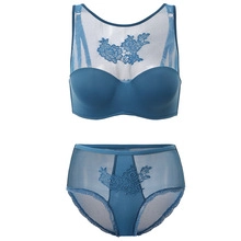 Detail view of peacock blue mesh bra set with floral embroidery and adjustable straps